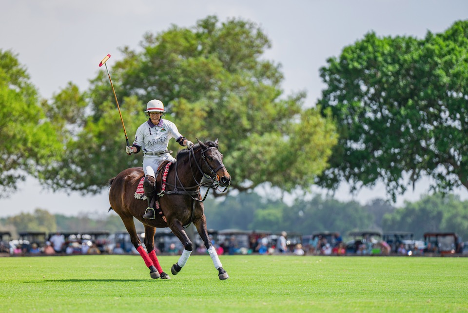A Polo Player with Golf Car Tailgating in the Background