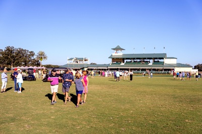 Spectators on the Polo field stomping divots
